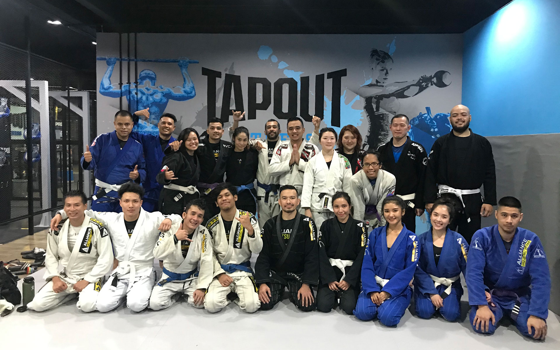 Two practitioners training Brazilian Jiu-Jitsu on the mat